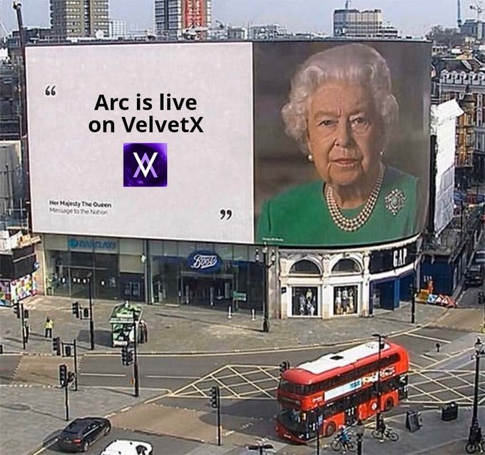 A billboard at Piccadilly Circus displays 'Arc is live on VelvetX' alongside a portrait of Queen Elizabeth II with the caption 'Her Majesty The Queen. Message to the Nation,' while a red double-decker bus passes below.