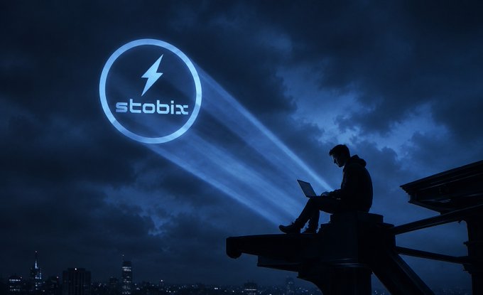 A silhouetted figure uses a laptop perched on a rooftop edge at night, while a glowing blue beam projects the "stobix" logo with a lightning bolt icon into the dark, cloudy sky above the city—visually reinforcing the post's message of Stobix as the empowering tool for market heroes.