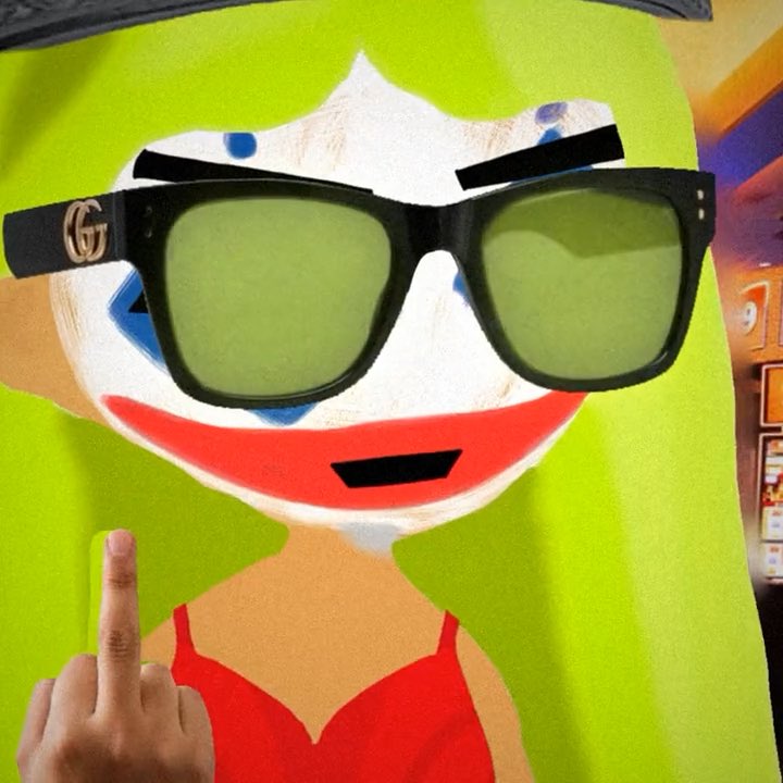 A whimsical scene featuring a clown face cutout with sunglasses and green-tinted lenses, with a hand in the foreground displaying the middle finger.