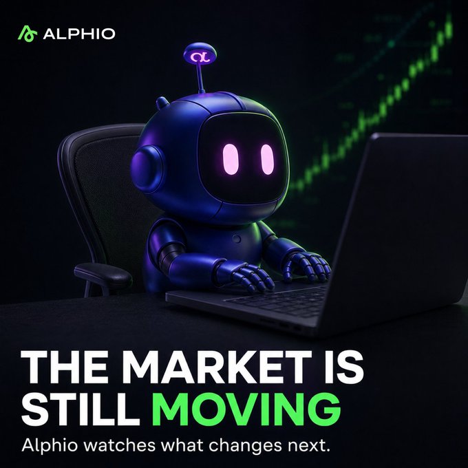 An advertisement for 'ALPHIO' features a dark blue robot at a laptop against a backdrop of a green rising stock chart, with the tagline 'THE MARKET IS STILL MOVING — Alphio watches what changes next.'