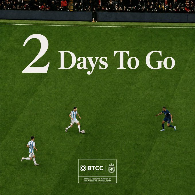 The image shows a group of soccer players running across a green field, with one player wearing a blue shirt and another wearing a white shirt. The text "2 days to go" is written above them, indicating that they have two more days before their game starts.