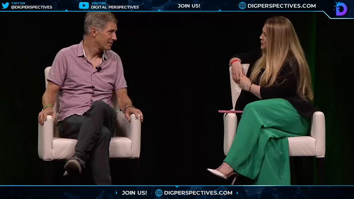 The image shows a man and woman sitting in chairs, engaged in conversation with each other. They are positioned across from one another, facing each other as they talk. The background of the image is black, which contrasts with the white chair that both individuals are seated on. There is also text visible in the image, including the words "Digital Perspectives" and "join us".