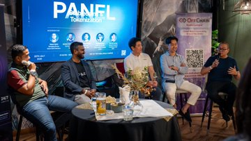A panel discussion with five men seated on stage at an event labeled 'PANFI Tokenization', featuring the 'Onyx Center' logo and a 'SCAN ME' QR code banner.