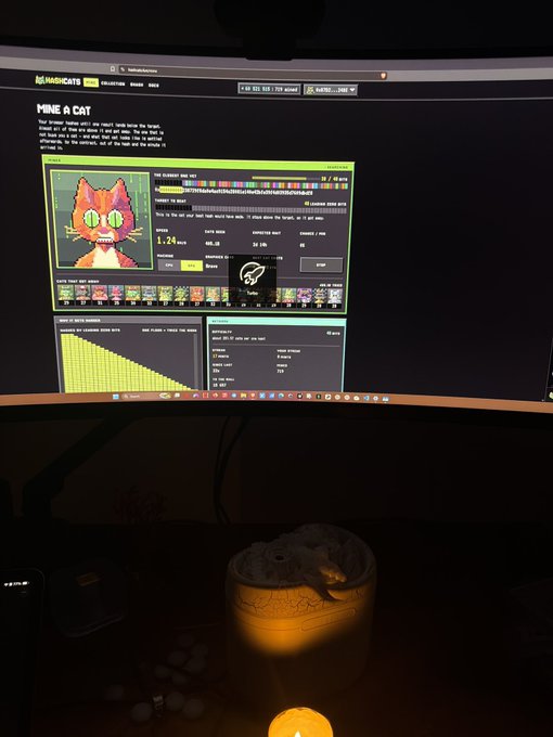 A curved monitor displays the Handshake (HNS) mining dashboard titled "MINE A CAT," showing a pixel-art cat NFT and active hashrates of approximately 1.24 kH/s, while a 3D printer illuminates the foreground as it fabricates a cat-shaped object—combining digital mining activity with the physical creation of a novelty item.