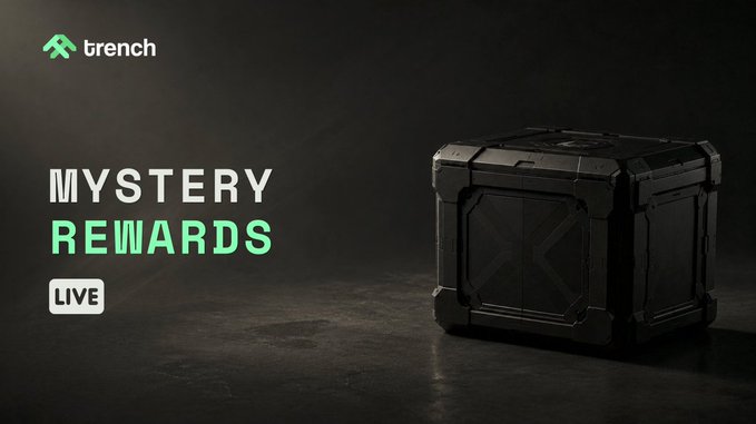 A promotional banner for 'trench' featuring 'MYSTERY REWARDS LIVE' text next to a dark metallic loot crate against a black background.