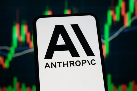 A smartphone displays the Anthropic AI logo against a backdrop of a stock market candlestick chart, visually representing the company's anticipated IPO that could reach a $2 trillion valuation.