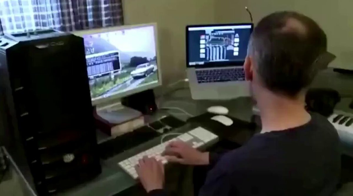 The image shows a man sitting at a desk with two computer monitors, one of which has an open laptop connected to it. The man appears to be focused on his work or gaming activities, possibly mining Bitcoins. The photo also includes text that reads "This guy was mining 1 bitcoin per day in 2013". This suggests that the man might have been engaged in Bitcoin mining during a specific period, likely between January and March of 2013.