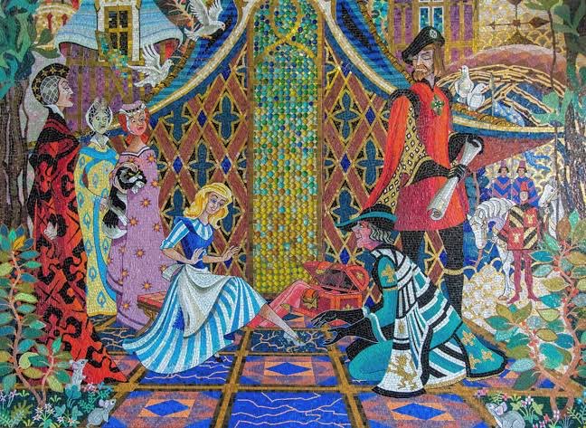 A colorful stained-glass style artwork depicts a scene from Cinderella, with Cinderella sitting on the floor near a knight and other figures in medieval attire.
