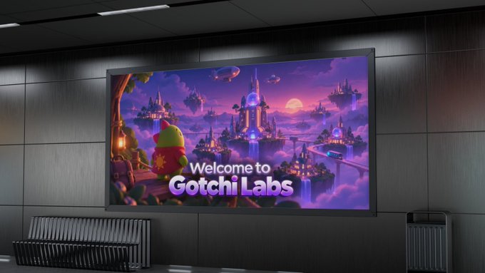 A wall-mounted display in what appears to be an airport or modern building showing a colorful 'Welcome to Gotchi Labs' promotional screen featuring a fantasy castle scene with purple skies and a cartoon frog-like character.
