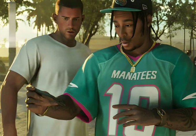 A scene from what appears to be a video game or CGI render showing two men, one in a teal Miami 'MANATEES' #18 jersey with gold chains holding a phone, and another man in a white t-shirt looking over his shoulder.