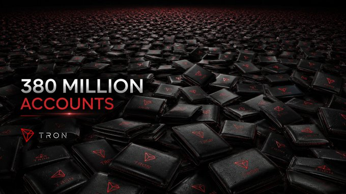 A vast field of black wallets embossed with the red TRON logo stretches across the image, accompanied by bold text reading "380 MILLION ACCOUNTS" and the TRON brand name, visually representing the massive scale of TRON's growing user base as it works toward building a frictionless global value network.