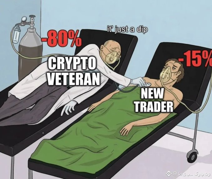 A cartoon comparing a 'CRYPTO VETERAN' at -80% down ('it just a dip') calmly helping a 'NEW TRADER' at -15% who appears more distressed, both wearing oxygen masks on hospital beds.