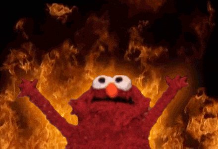 urn of fire with flames licking the sides, casting a warm glow on a red-haired character named Elmo standing against a dark background.