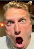 A blonde man with a comically shocked and horrified expression, his mouth wide open and eyes bulging, perfectly capturing the disbelief of someone seeing the "$CASHCAT" chart's unexpected downturn.