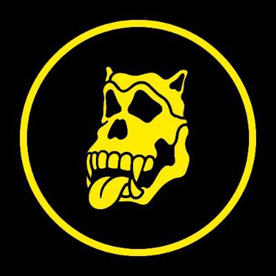 A yellow circular logo on a black background depicting a stylized skull with horns and an extended tongue.