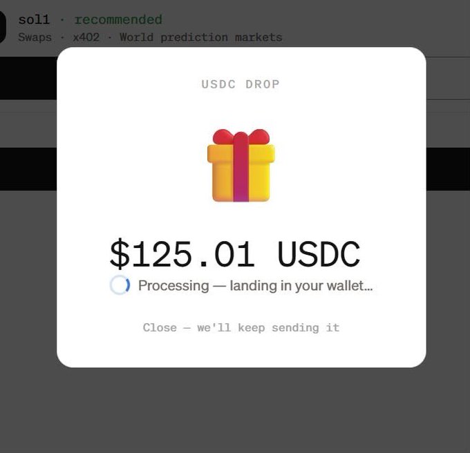 A modal popup titled "USDC DROP" confirms a $125.01 USDC reward is processing and landing in the user's wallet, with a gift icon and a note that clicking "Close" will keep sending it. The image illustrates the successful redemption of a Moonpay Paybox airdrop mentioned in the post, showing the USDC reward being deposited.