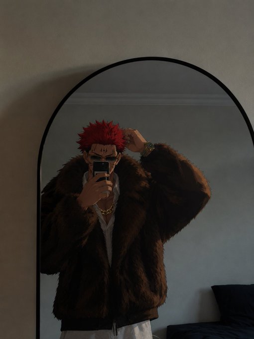 A person takes a mirror selfie wearing a fuzzy brown jacket and a spiky red anime-style wig.