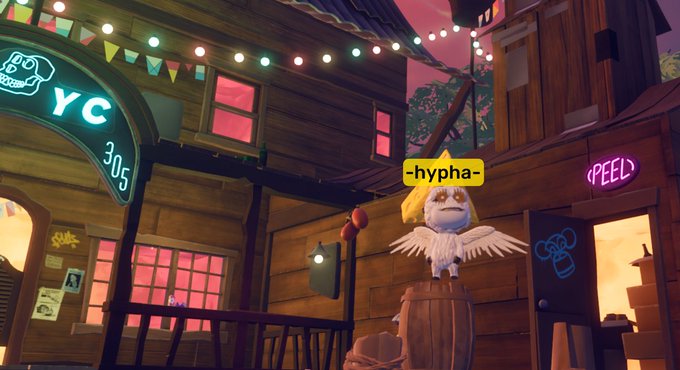 A whimsical 3D-rendered game scene shows a small owl character with a star on its head labeled '-hypha-' perched on a barrel in a village setting with neon signs reading 'YC 305' and '(FEED)'.