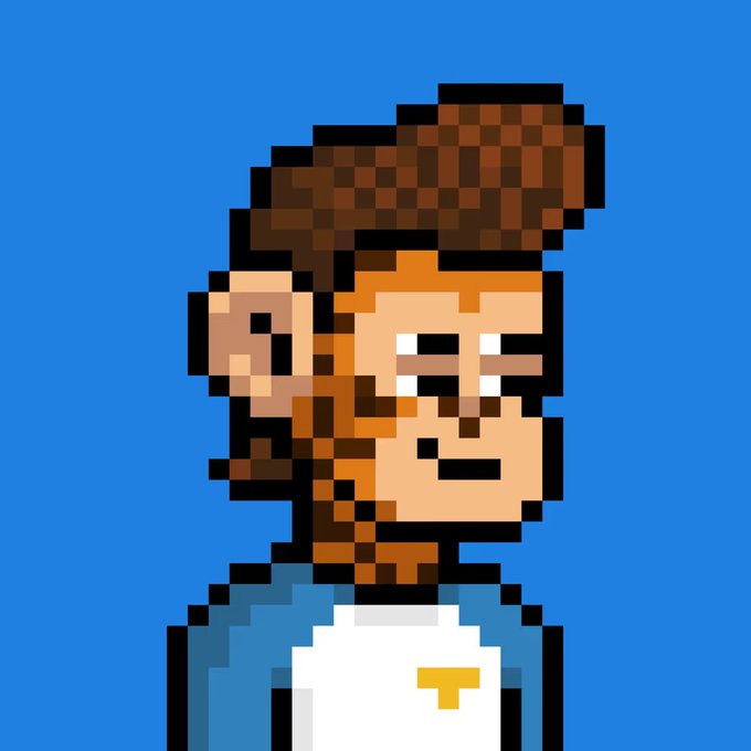 A pixel art character portrait shows a person with brown hair styled up, wearing a white shirt with a blue collar and a yellow 'T' logo, set against a solid blue background.