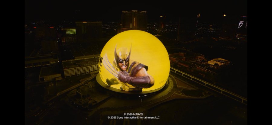 A massive spherical screen displays a striking image of Wolverine from the Marvel X-Men, with the character's iconic yellow mask and extended claws emerging dramatically against a glowing yellow background, set against the nighttime Las Vegas skyline. The image is credited as artwork on the @SphereVegas, with copyright text at the bottom reading "© 2026 MARVEL" and "© 2026 Sony Interactive Entertainment LLC."