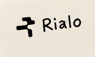 A hand-drawn logo featuring a stylized 'R' symbol next to the word 'Rialo'.