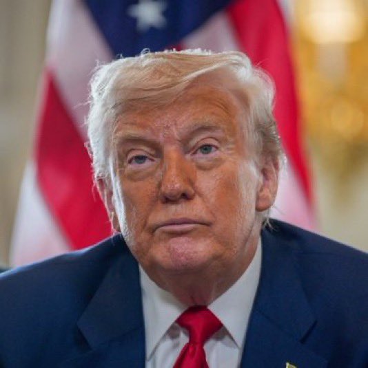 The image shows Donald Trump in a dark suit and red tie, standing before an American flag with a serious expression. The caption "This face rings a bell from somewhere, but" humorously plays on the universal recognition of Trump while pretending to struggle with identifying him.