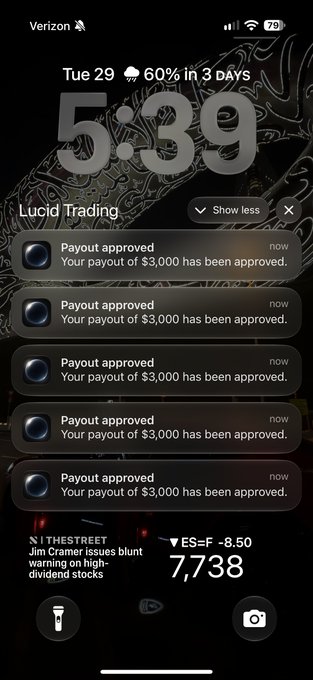 A smartphone lock screen showing the time '5:39' on Tuesday the 29th, with multiple notification banners from 'Lucid Trading' stating 'Payout approved - Your payout of $3,000 has been approved' repeated several times, along with an ES=F stock ticker showing 7,738 at -8.50.