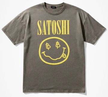 The image features a gray t-shirt with a yellow smiley face design, which has the words "Satoshi" written above it. The text is in white letters against the gray background of the shirt. Below the main design, there's a smaller version of the same smiley face and the word "Satoshi". This smaller design also includes the words "B Bitcoin T-shirt" printed below it.