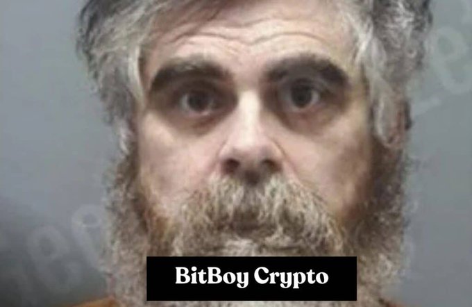 A mugshot-style photo of a bearded man with wide eyes, labeled "BitBoy Crypto" at the bottom.