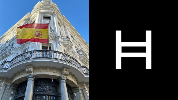 A Spanish flag waves atop an ornate building beside a white "H" logo on black, representing Hedera (HBAR). The image illustrates the milestone of five major Spanish banks completing the first HBAR tokenized deposit within Spain's $2+ trillion banking system.