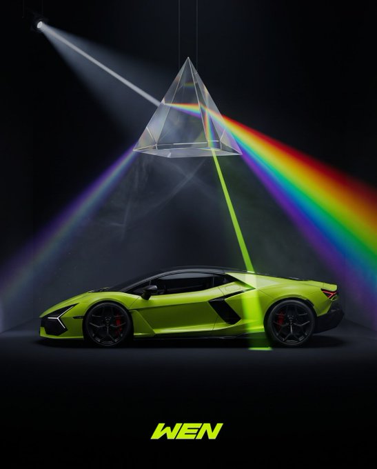 A vibrant green Lamborghini is illuminated by a spotlight passing through a triangular prism that disperses the light into a rainbow spectrum, symbolizing the speculative and meme-driven frenzy on Robinhood. The watermark "WEN" at the bottom reflects the post's reference to Robinhood as the racetrack for memes, evoking the anticipation of quick gains among retail traders.
