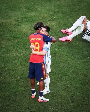 Two soccer players, one wearing a Spain #9 'Laporte' jersey, embracing on a green field during what appears to be a Euro 2024 match.