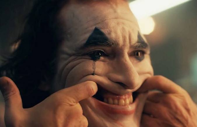 A close-up cinematic shot of the Joker character with smeared clown makeup, forcing an exaggerated smile with his fingers, in the style of the 2019 film.