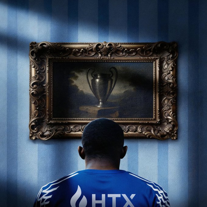 A person in a blue jersey with "HTX" on the back gazes up at an ornate gilded painting of a trophy, symbolizing ambition and the pursuit of excellence. The image visually echoes the post's themes of building, trading, and striving for success with HTX, framing their work as a quest for a coveted prize.