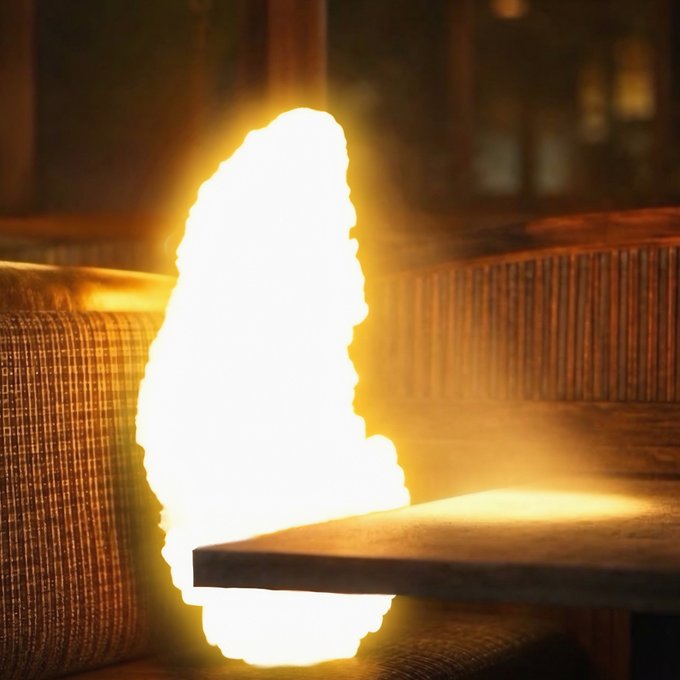 A bright, elongated flame burns intensely between wooden surfaces in a dimly lit industrial setting, casting a warm glow on the surrounding wood grain.