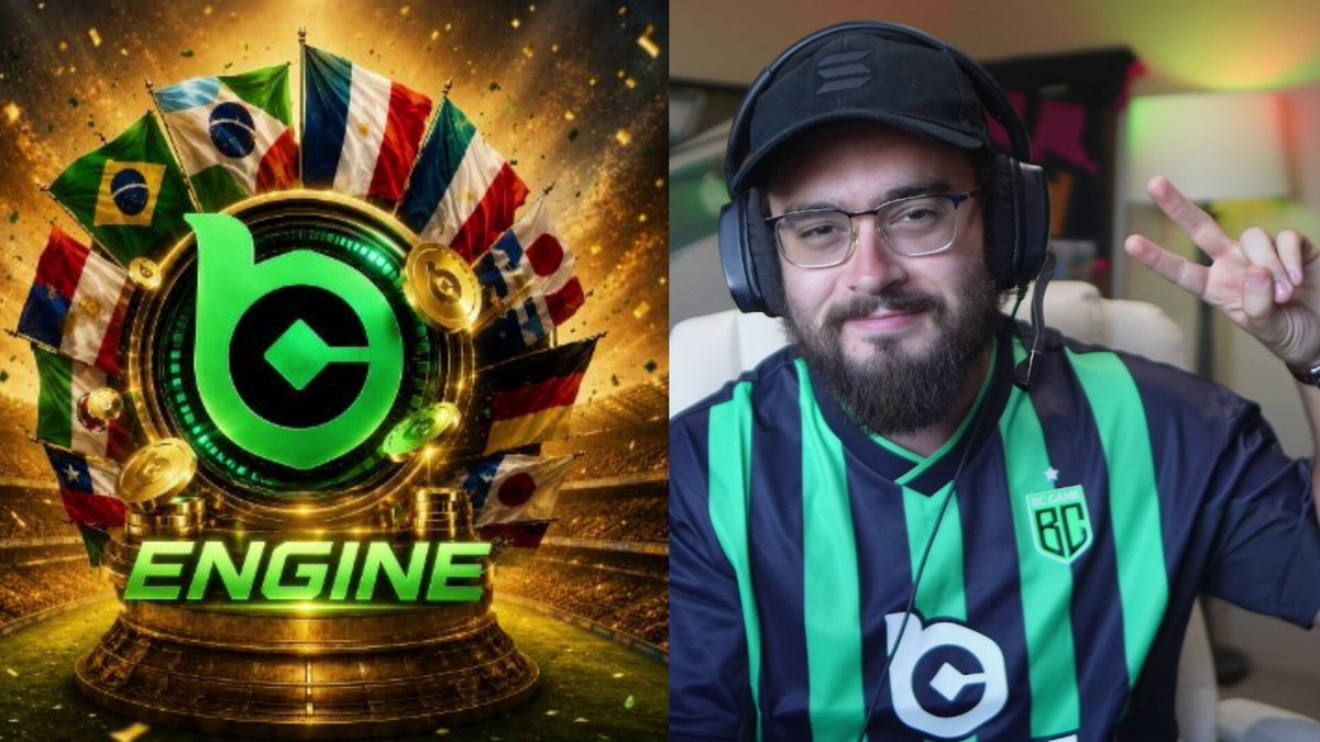 The image features a man wearing a green and black striped shirt, with a large logo of the Engine company displayed above him. The man has a beard and is smiling for the camera while posing next to a poster or advertisement related to the Engine game. The poster includes various flags from different countries, indicating that it might be promoting an international gaming event or tournament.