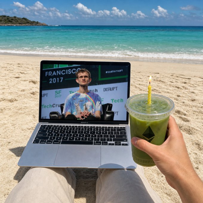 A first-person view from a beach showing a MacBook displaying Vitalik Buterin at TechCrunch Disrupt SF 2017, alongside a hand holding a green drink cup with an Ethereum logo straw.