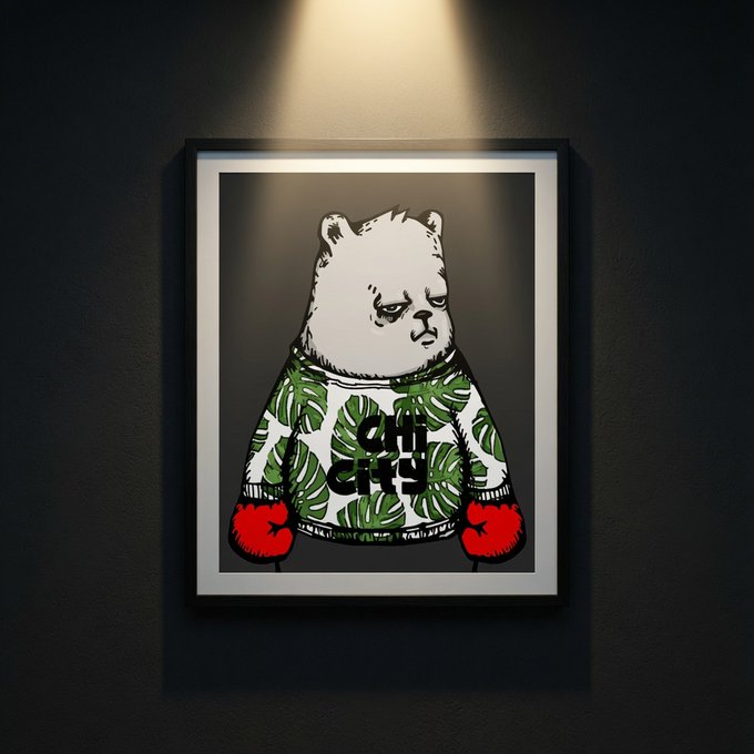 A framed poster on a dark wall under a spotlight, depicting a stylized bear wearing a green leaf-patterned sweater with 'OFF GRID' text and red boxing gloves.