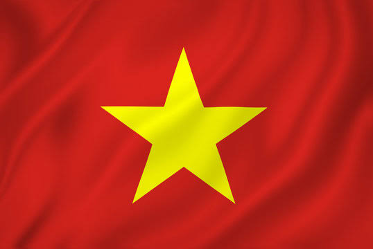 A waving Vietnamese flag featuring a large yellow star centered on a red background. The image relates to Vietnam's new regulations imposing fines on crypto traders for using unlicensed platforms.