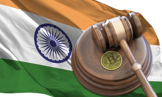 A wooden gavel rests on a sounding block atop the Indian flag, with a physical Bitcoin coin placed beside it—symbolizing the intersection of India's legislative authority and the emerging cryptocurrency regulation discussions taking shape in Parliament.