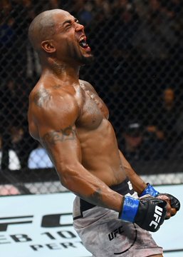 A shirtless MMA fighter wearing UFC gloves screams in celebration inside the cage, referencing King Green who is set to face Esteban Ribovics with a 35% implied probability on Polymarket. The banner behind him reads "ESPN+" and "DEC 10," highlighting the upcoming fight card.