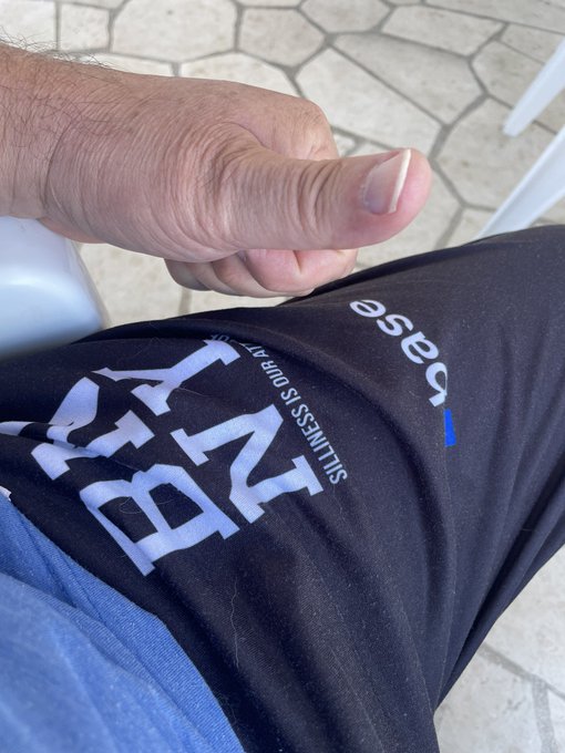 A close-up photo shows a hand giving a thumbs-up gesture over black athletic shorts that display the text "NB" and "new balance SUITNESS is our" alongside the Rease logo.