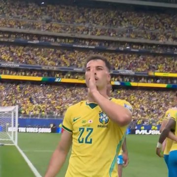 A soccer player in a yellow Brazil jersey with the number 22 celebrates on the field with a large crowd in yellow visible in the stadium background, with text overlays reading 'THE VIBE COMES' and 'PULSAR'.