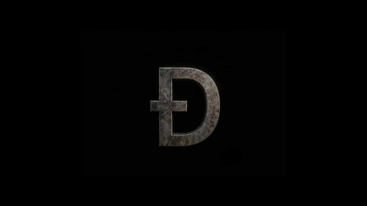 "The Ðark Knight" is a movie title that appears at the bottom of the image, with the text "focus on what is in the image and how it relates to the post." The image features a large, metallic letter "D" against a black background, which stands out prominently.