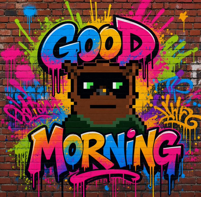 Vibrant graffiti street art on a brick wall featuring a pixel-art style character wearing green, surrounded by colorful paint splatters and the large text 'GOOD MORNING' in rainbow gradient lettering.