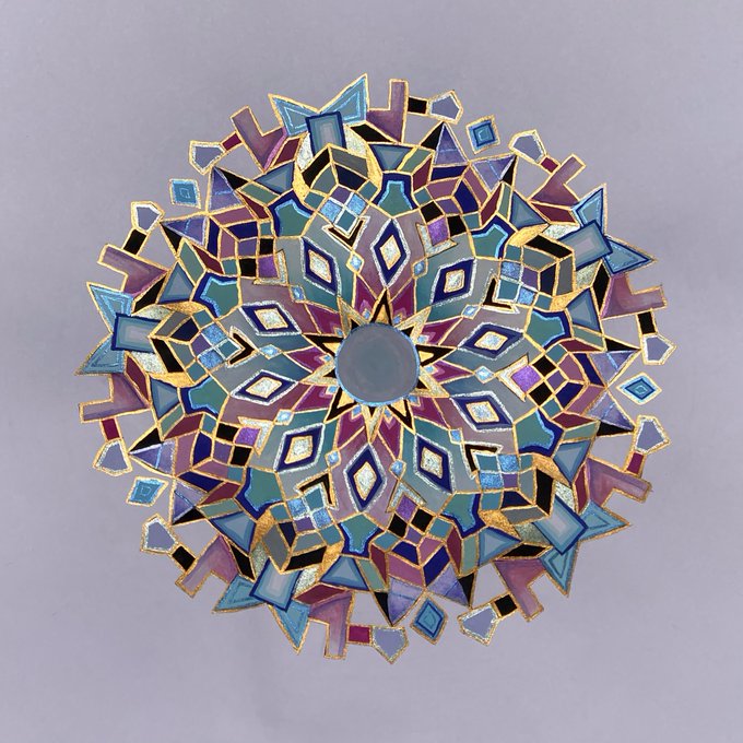 An intricate, circular geometric mandala design composed of various shaded polygons in shades of purple, blue, and green, outlined with thin gold lines on a light grey background.