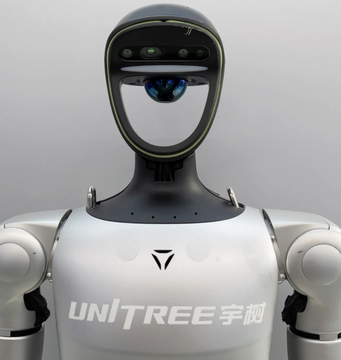 A humanoid robot by UNITREE (宇树) featuring a sleek white body and a distinctive face-shaped visor/sensor head.