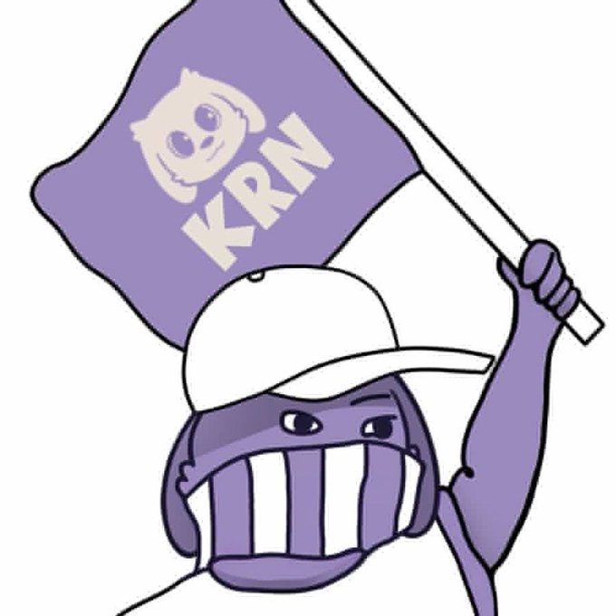 A purple-toned cartoon illustration of a character wearing a baseball cap and grinning widely while waving a flag that reads 'KKRN' with a stylized animal logo.