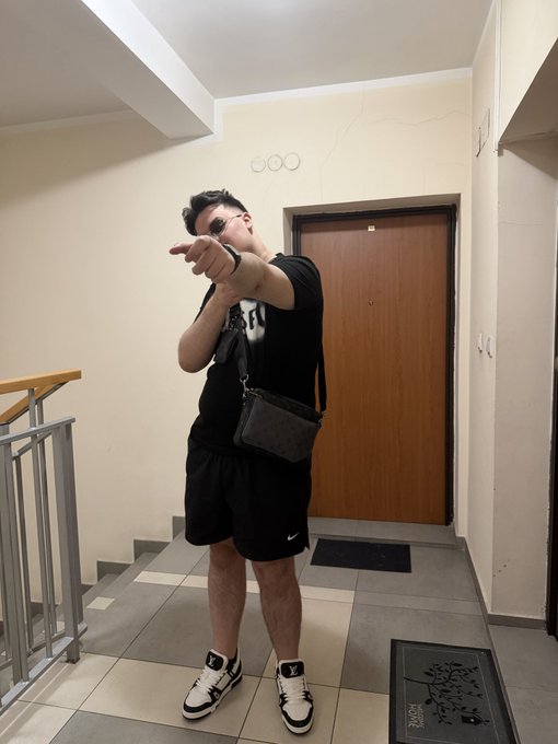A man in a black t-shirt, shorts, sunglasses, and Air Jordan sneakers stands in a hallway pointing at the camera, with a door labeled "300" behind him. The casual, selfie-style pose with a pointing gesture matches the energetic, giveaway-style tone of the post promoting a 30 USDT random-draw contest.