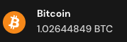 A dark screen displays the Bitcoin logo and ticker 'Bitcoin' with a balance of '1.02644849 BTC'.
